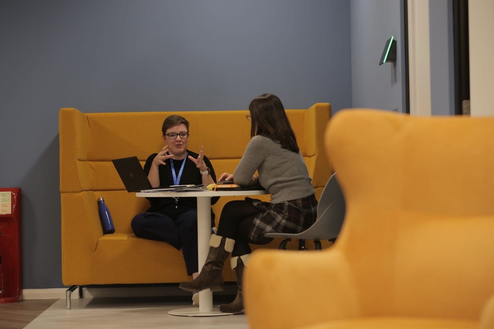 two women talking in a booth