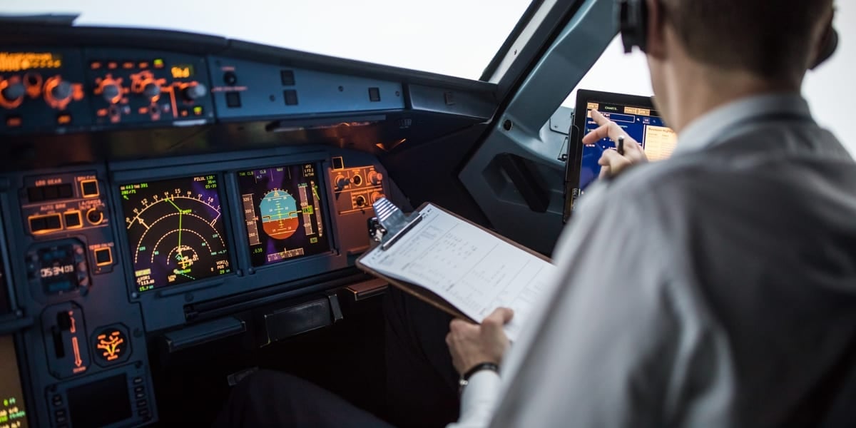 pilot running diagnostics in cockpit