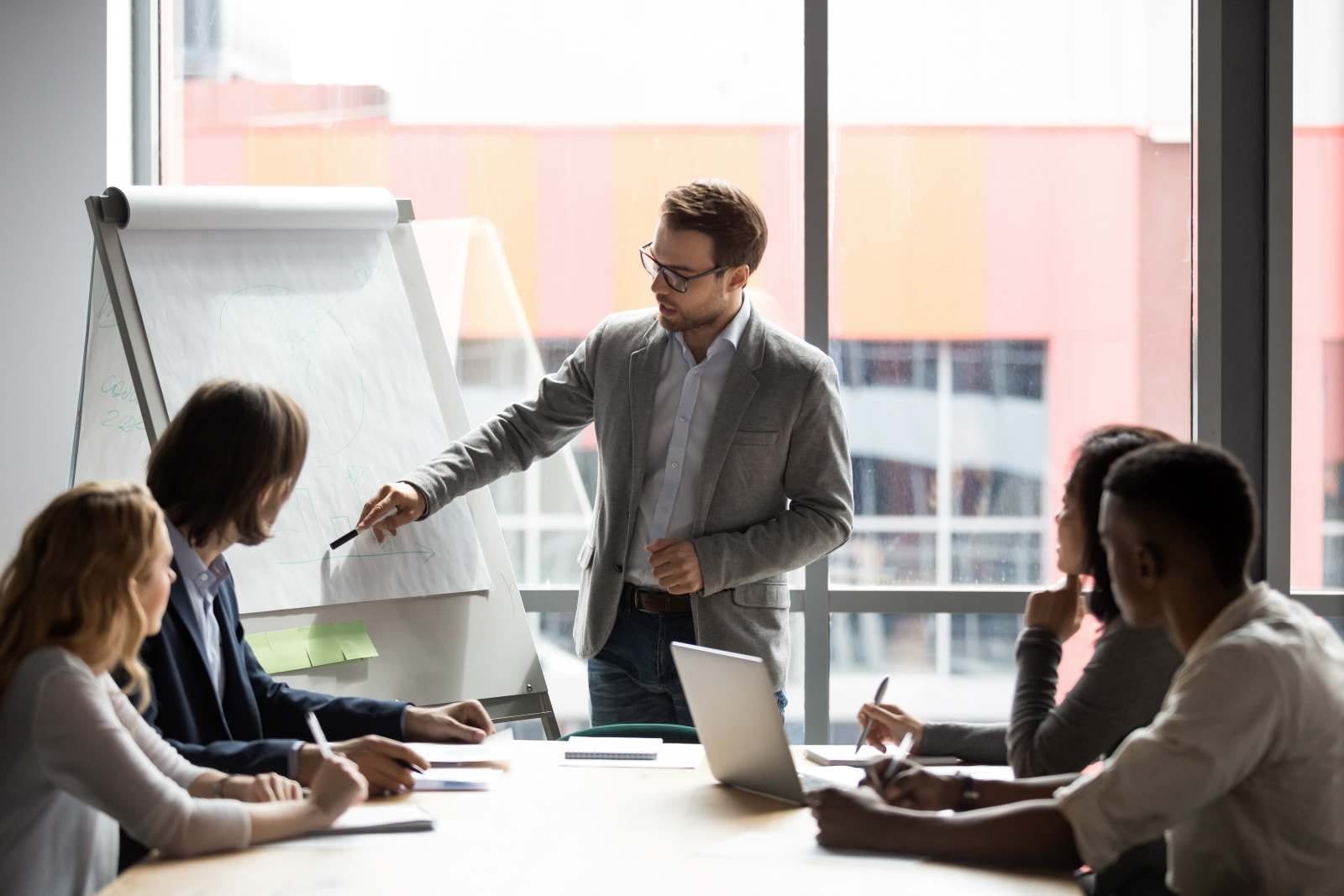 man presenting to a small group of people