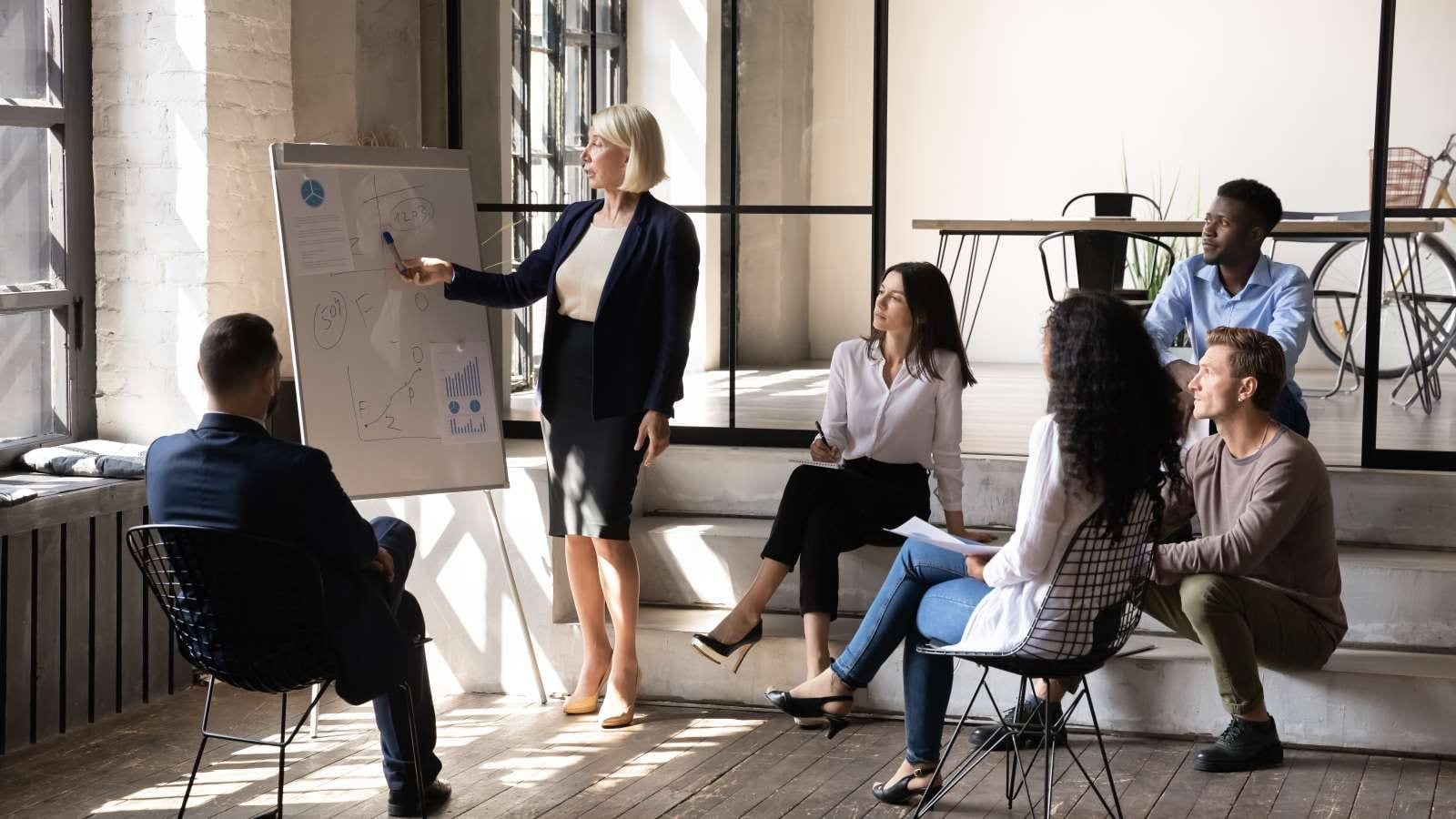 woman presenting to a small group of people