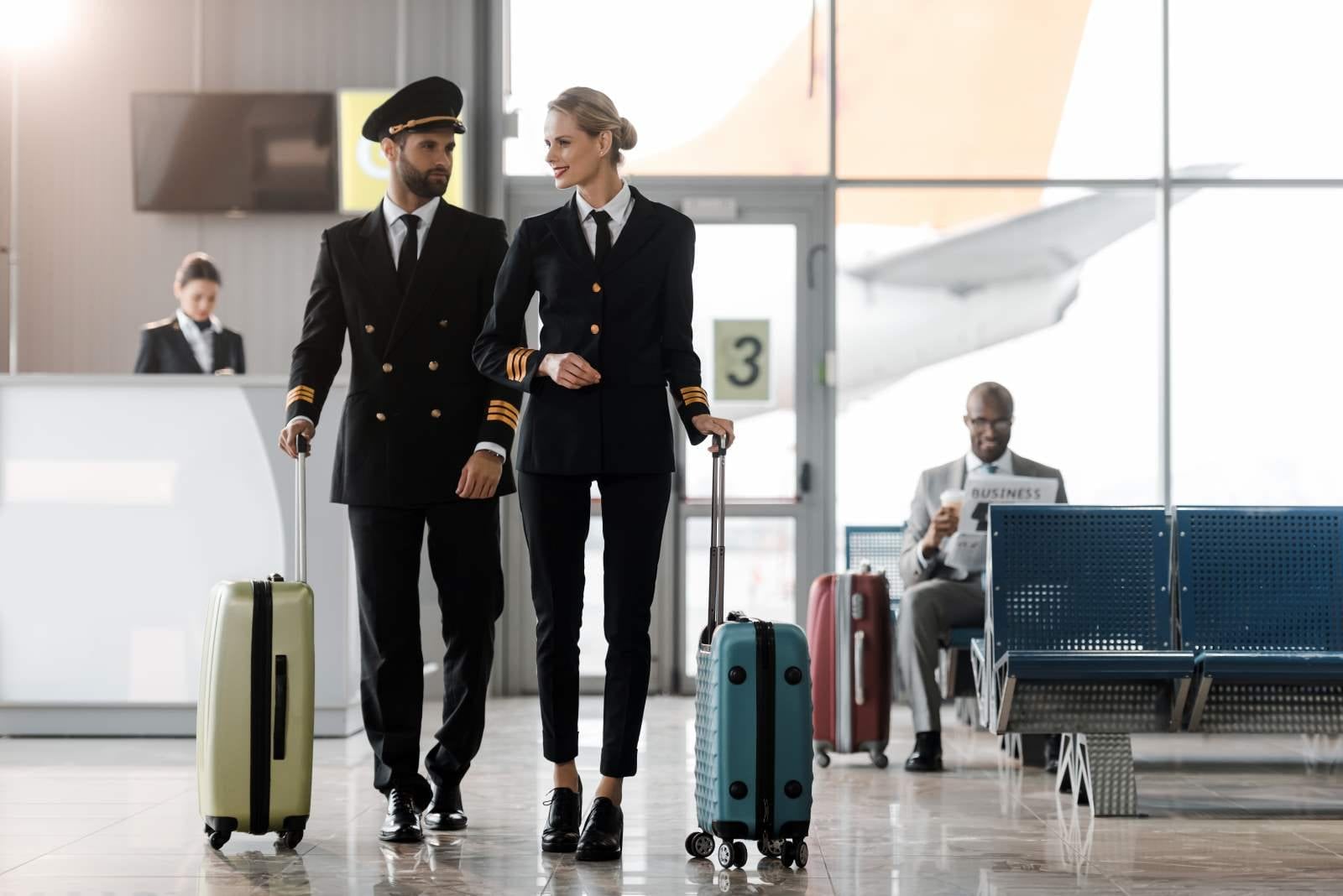 man and woman pilot walking with luggage