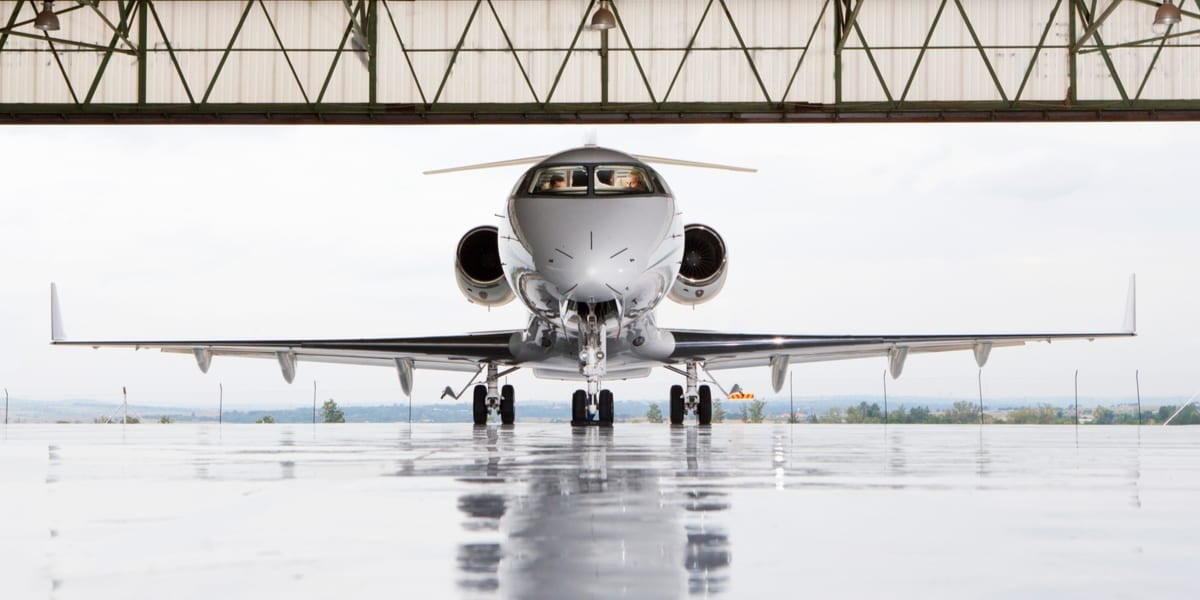 white aeroplane parked in hangar