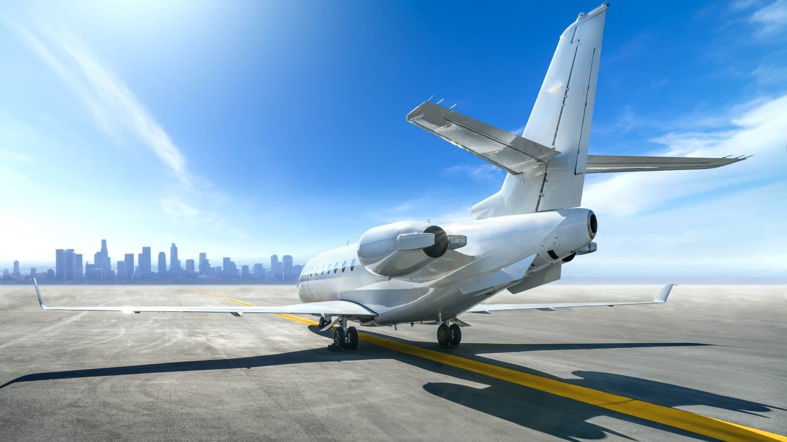 aeroplane parked with city in distance