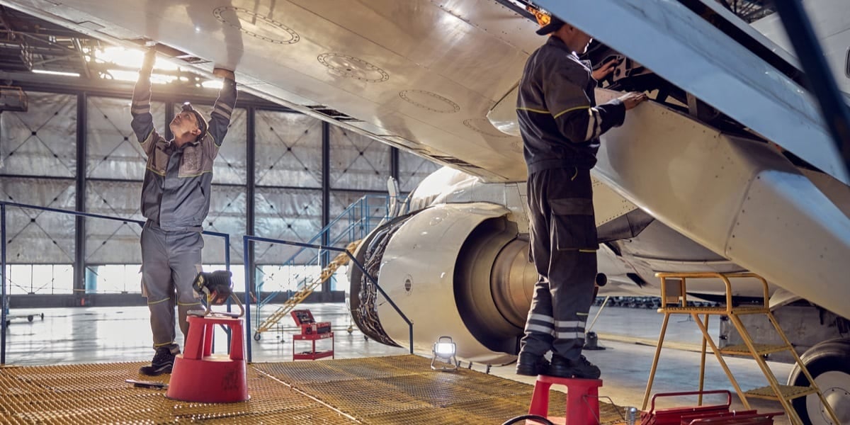 two engineers under an aeroplane