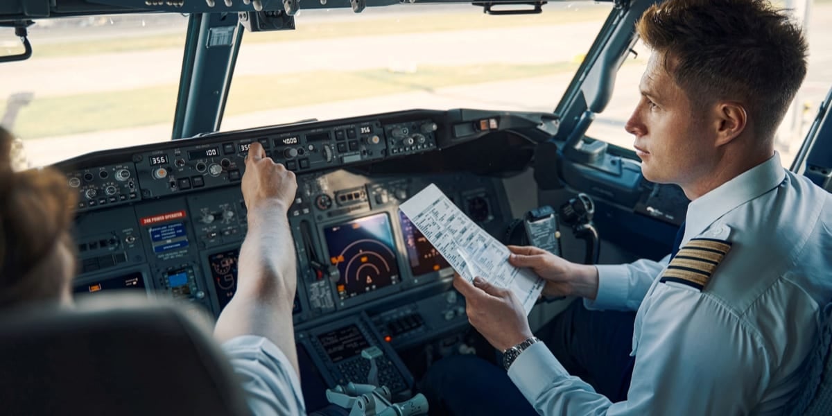 two pilots in cockpit doing assessment